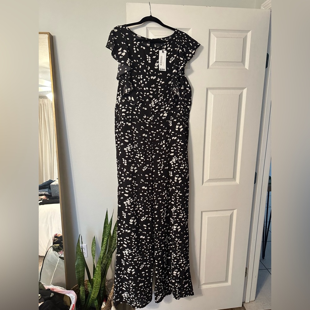 Brand new black and white jumpsuit with ruffle sleeves